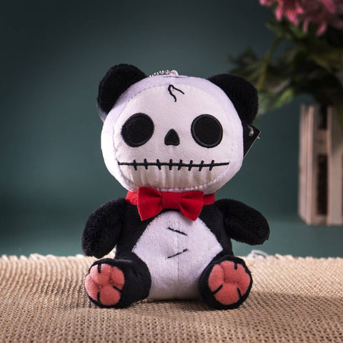 Image shows a stuffed panda, stitched together in various places. It has a skeleton-like face.