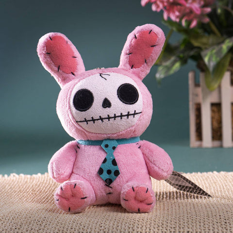 Image shows a pink horror bunny stuffed animal. Its body is stitched together with black thread and is holding a knife.