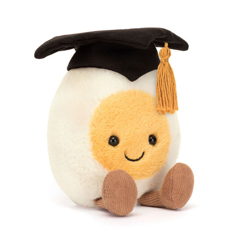 Image shows a stuffed hardboiled egg wearing a graduation cap. It has a happy face and feet.