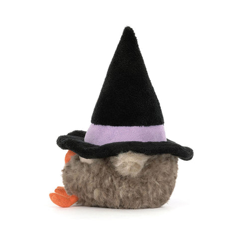 Side view of the plush owl wearing a witch's hat