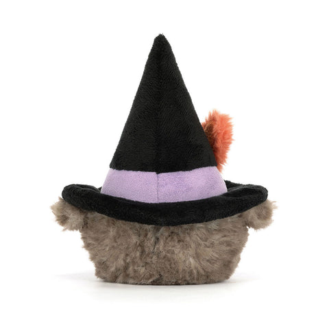 Back view of a plush owl toy wearing a witch's hat