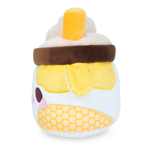 Side view of a plush milkshake in a yellow cow-themed cup