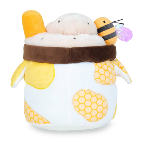 A plush milkshake in a yellow cow-themed cup with a bee on top