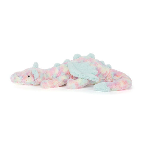 Side view of a plush dragon toy with tie-dye pattern on a white background