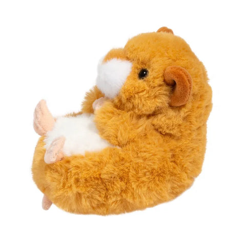 A side view of the plush baby hamster. It is curled up.