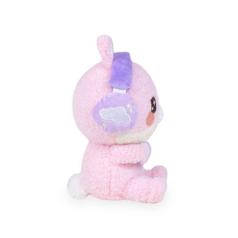 Side view of a plush pink gamer bunny wearing purple headphones with a cloud and stars on the side