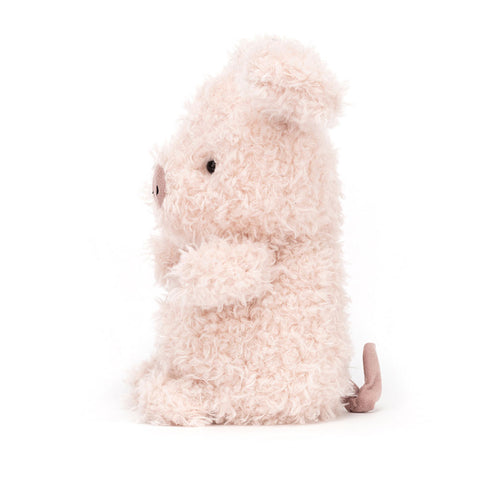 Image shows a side view of the stuffed pig. Its tail is curly.
