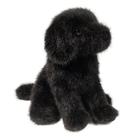 A side-angle view of the plush black lab