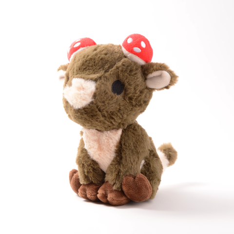 A brown plush cow with red and white mushrooms on its head
