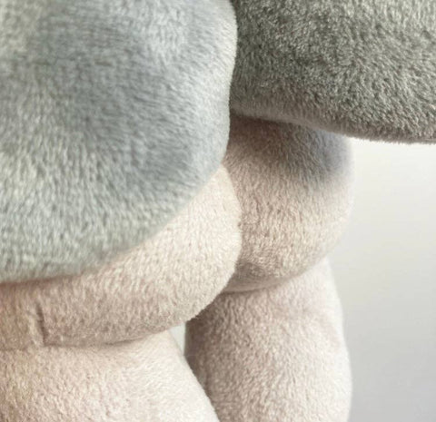 Close up view of the grey plush mothman's backside 