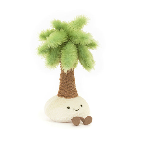 Image shows a stuffed palm tree growing out of a pile of sand. The sand has feet and a happy face.