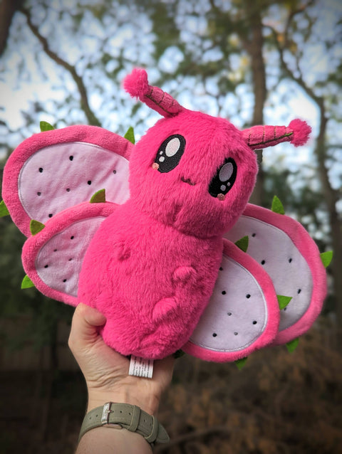 Image shows a dragon fruit themed stuffed moth.