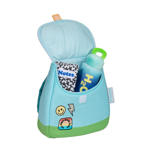 Image shows the open backpack with a plush notebook and water bottle sticking out.