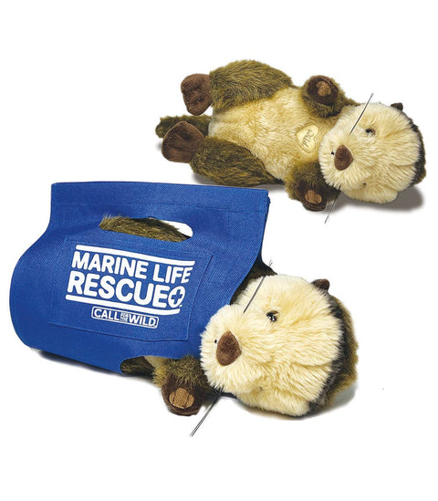 Image shows a stuffed sea otter both in a rescue sling and outside of it
