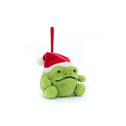 Green plush frog with a red Santa hat on a white background. It hangs from a red ribbon.