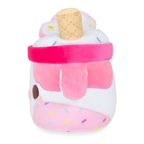 Side view of a plush milkshake in a pink cow-themed cup