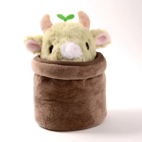 The sprout cow peeking out of a brown plush pot