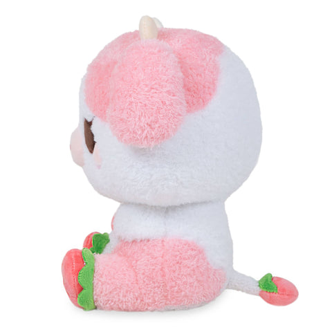 Side view of a plush pink & white strawberry-themed cow on a white background