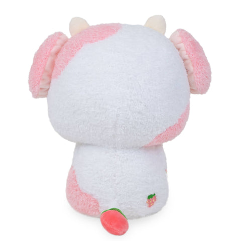 A back view of a plush pink & white strawberry-themed cow