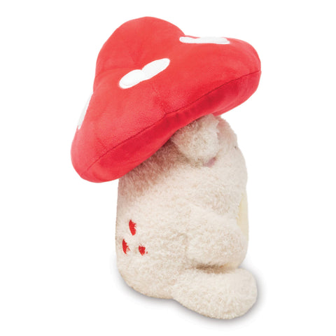 Image shows a side view of the stuffed frog with the mushroom hat