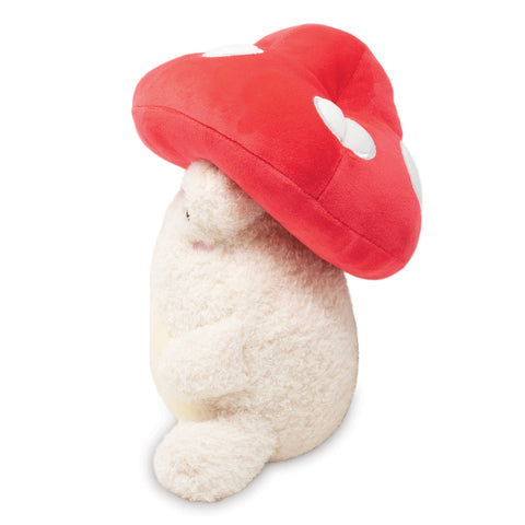 Image shows a side view of the stuffed frog with a mushroom hat