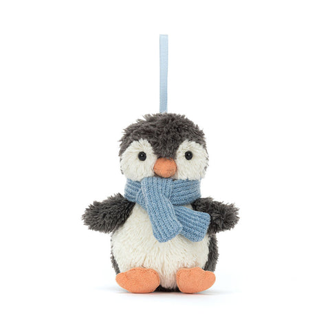 Plush penguin toy with a blue scarf on a white background. It hangs from a blue ribbon.