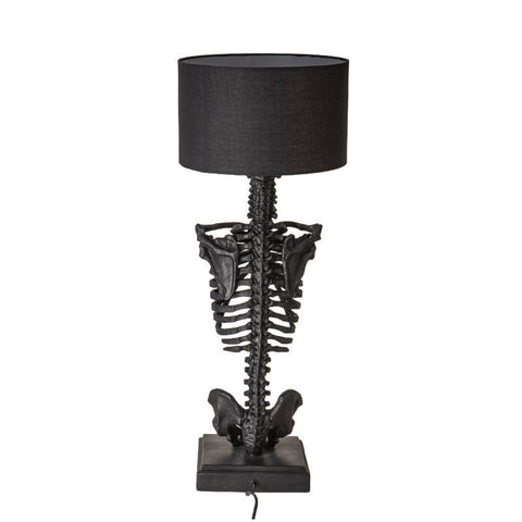 Image shows a black resin lamp. It is a skeleton from the top of the spine to the pelvis and has a black shade.