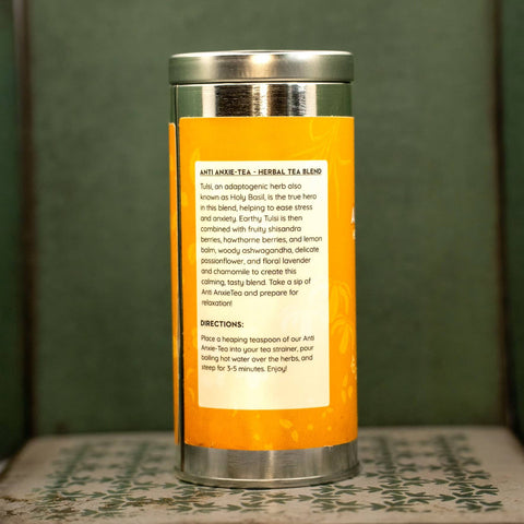 Herbal tea blend container with orange label and silver lid. Label describes tea and gives instructions.