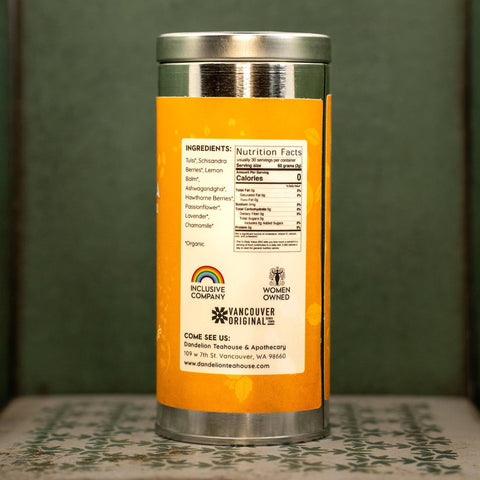 Container with herbal tea blend with an orange label. Label lists ingredients and nutrition facts.