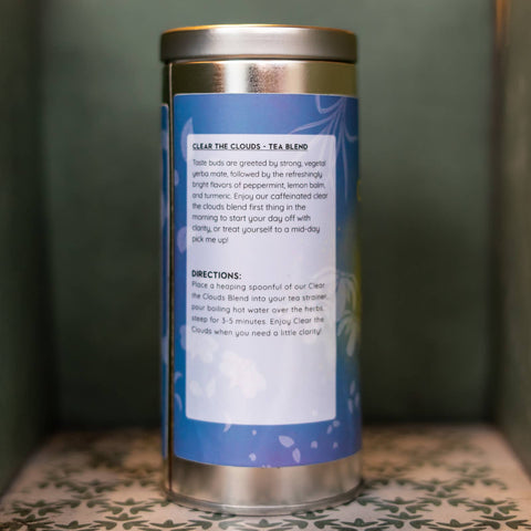 Tea canister with blue label on a patterned surface. Label describes tea and gives directions.
