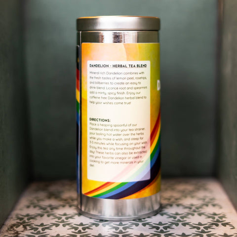 Tea canister with rainbow label on a patterned surface. Label describes tea blend and gives directions.