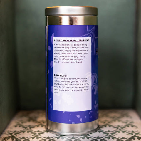 Tea canister with a blue label on a patterned surface. Label describes tea and gives directions.