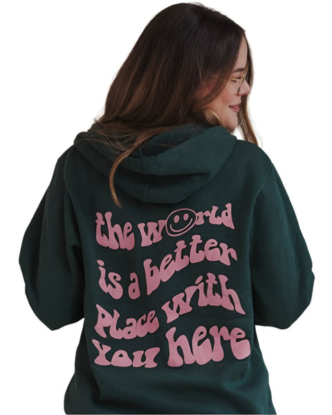 Black hoodie with mauve text: "the world is a better place with you here". The "o" in world is replaced with a smiley face.