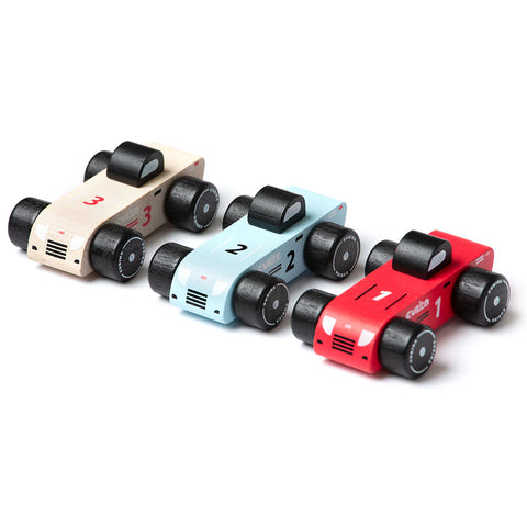 Image shows a top view of the three wooden cars. One is tan, one light blue, and one red.