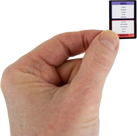 Image shows an adult hand holding one of the tiny Taboo cards. It is about the size of half of a finger.