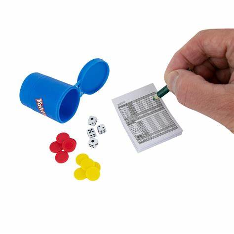 Image shows an adult hand next to the world's smallest yahtzee. The score card is slightly smaller than the palm.