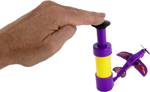 Image shows the air hogs next to an adult hand. He has two fingers on the plunger.