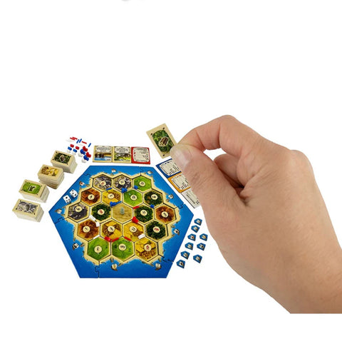 Image shows the world's smallest Catan game laid out. The cards are approximately the size of an adult's tumbnail.