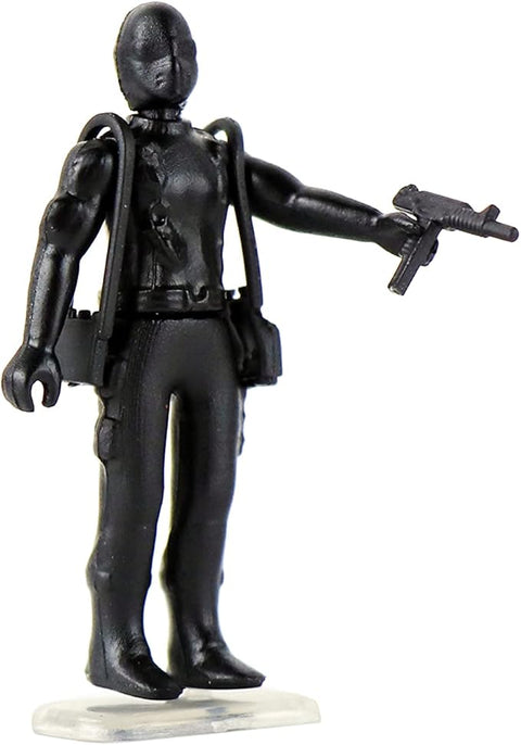 Image shows one of the world's smallest figurines. He is dressed head to toe in black and carries a gun.