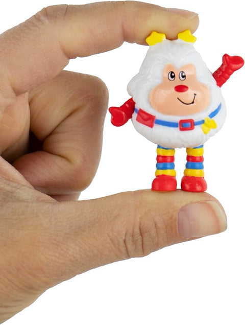 Image shows the world's smallest Twink held between an adult's thumb and forefinger