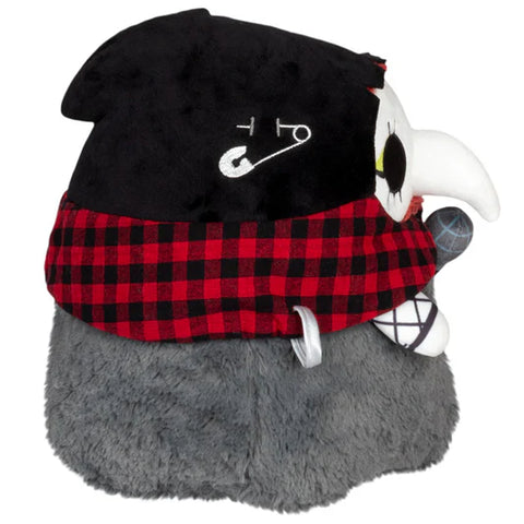 Image shows a side view of the stuffed punk rock plague nurse. Her bonnet is black with a safety pin in it.