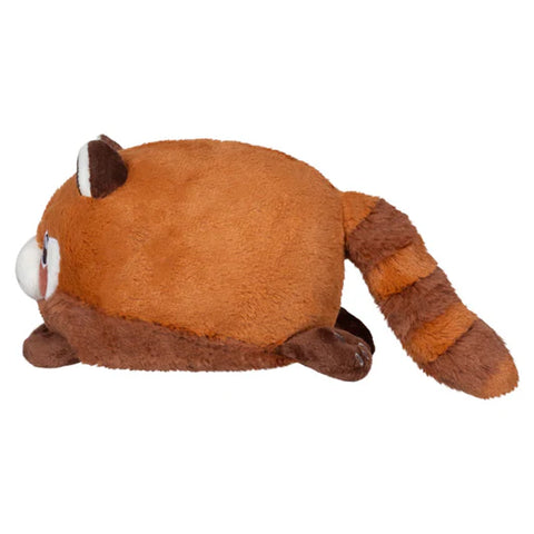 Image shows a side view of the stuffed red panda. Its body is very round.