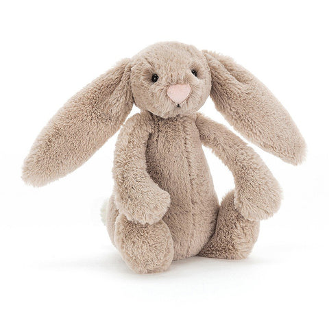 A stuffed beige bunny with floppy ears