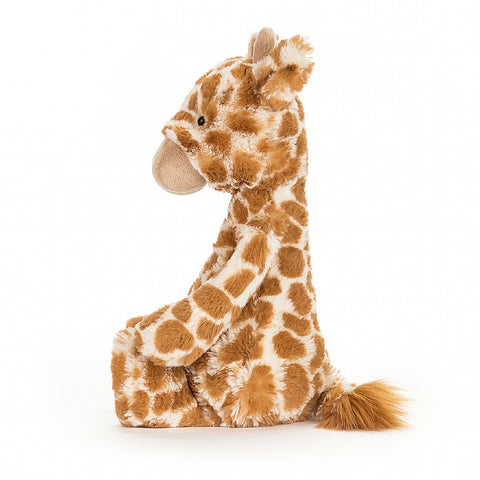 A side view of the same stuffed giraffe