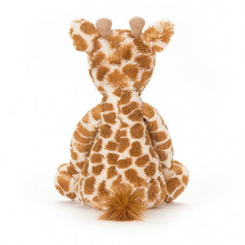 A back view of the same stuffed giraffe