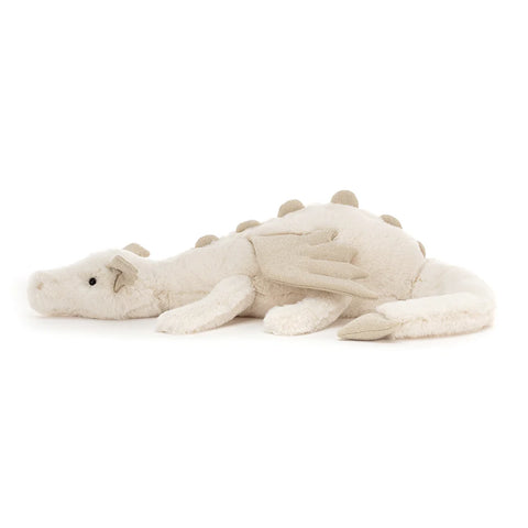 A side view of the white stuffed dragon