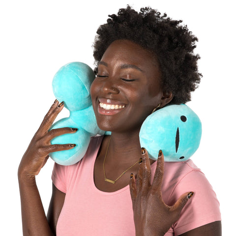 Image shows an African American woman with the penis neck pillow around her neck