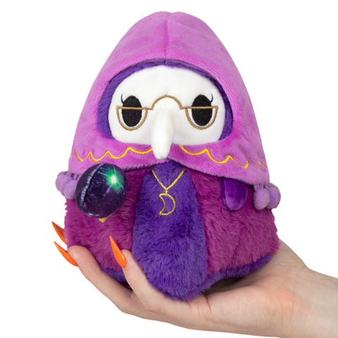 A plush toy resembling a fortune-telling plague doctor with a purple hood and glasses, holding a crystal ball.