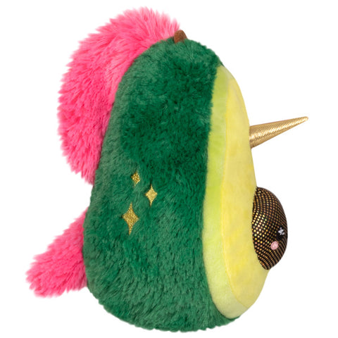 A side view of the plush unicorn avocado. It has a bright pink mane and tail