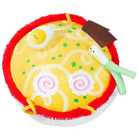 A top-down view of the plush ramen bowl, showing the ramen fabric, an egg, and a green onion.